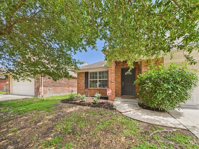 26940 Carriage Manor Ln, Kingwood, TX 77339 - view of front facade with a garage, brick siding, and driveway