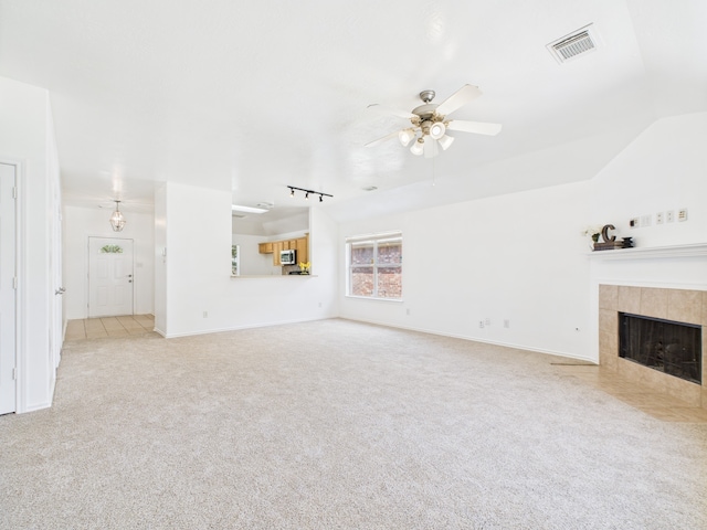 26940 Carriage Manor Ln, Kingwood, TX 77339 - unfurnished living room with a ceiling fan, a fireplace, carpet, and baseboards