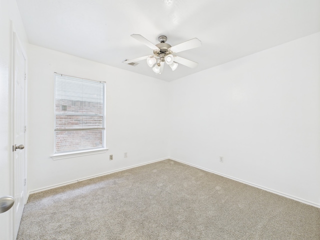 26940 Carriage Manor Ln, Kingwood, TX 77339 - empty room featuring carpet floors, a ceiling fan, and baseboards