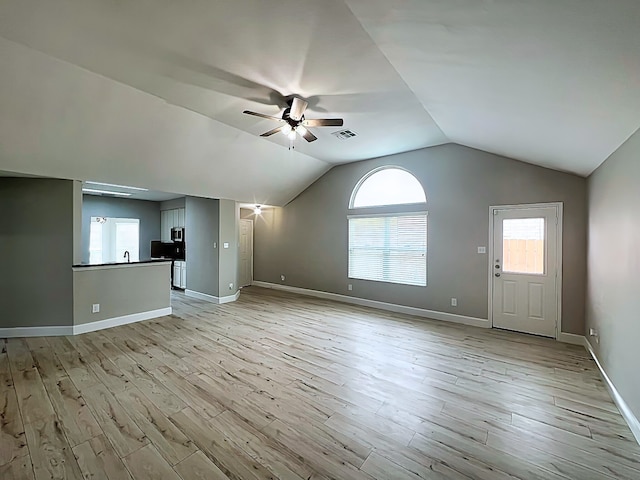 29375 Alba Rose Dr, Spring, TX 77386 - unfurnished living room with ceiling fan, light wood finished floors, baseboards, and vaulted ceiling