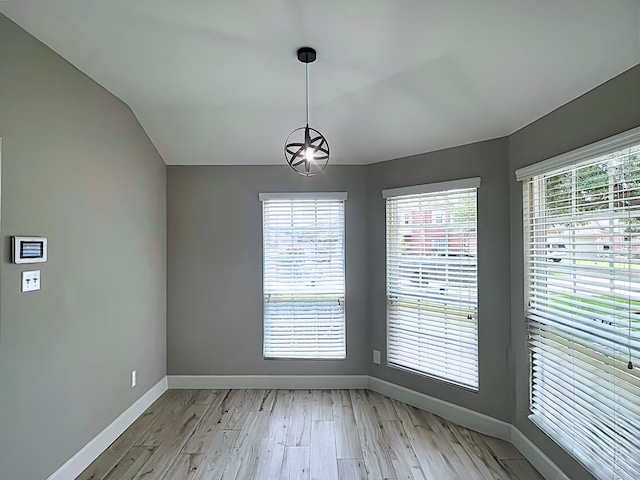 29375 Alba Rose Dr, Spring, TX 77386 - unfurnished dining area with baseboards, light wood-style flooring, and lofted ceiling