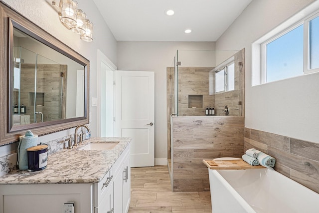 22212 Cantina Dr, Galveston, TX 77554 - full bath featuring a shower stall, a freestanding tub, vanity, recessed lighting, and wood finished floors