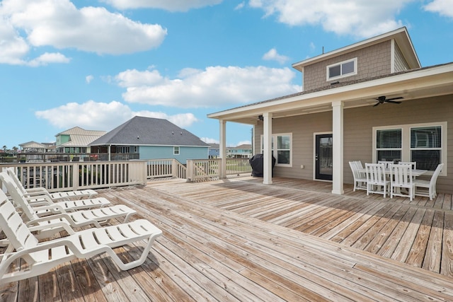 22212 Cantina Dr, Galveston, TX 77554 - wooden deck with a ceiling fan and outdoor dining area
