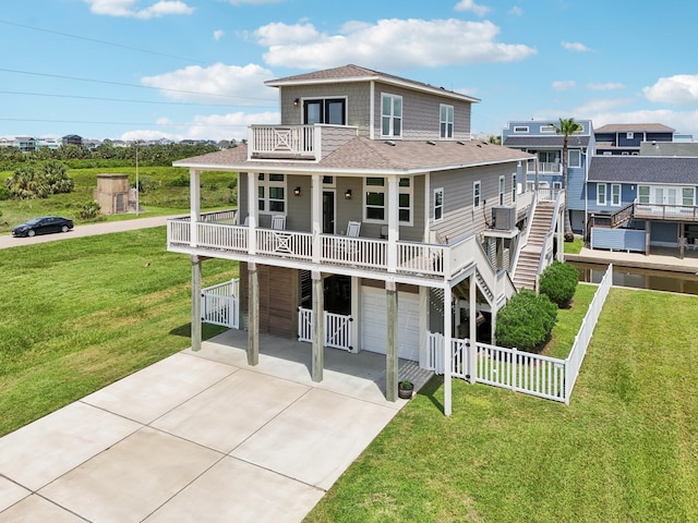 22212 Cantina Dr, Galveston, TX 77554 - view of front facade with an attached garage, a balcony, driveway, and roof with shingles