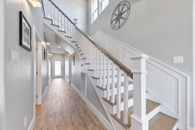 22212 Cantina Dr, Galveston, TX 77554 - stairway with a high ceiling and wood finished floors
