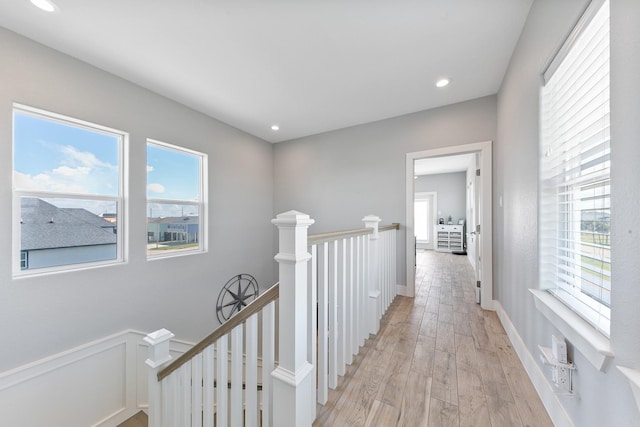 22212 Cantina Dr, Galveston, TX 77554 - hall with an upstairs landing, plenty of natural light, light wood-style floors, and recessed lighting
