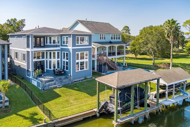 211 Valmar St, Kemah, TX 77565 - back of house with boat lift, a water view, a balcony, and roof with shingles