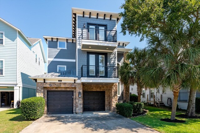 211 Valmar St, Kemah, TX 77565 - view of front of property featuring a balcony, french doors, an attached garage, and driveway