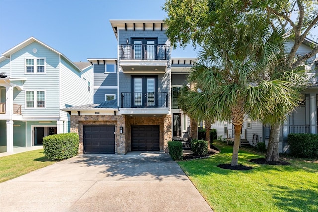 211 Valmar St, Kemah, TX 77565 - view of front facade with a balcony, french doors, concrete driveway, and a front yard