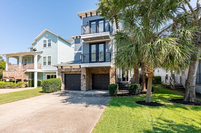 211 Valmar St, Kemah, TX 77565 - view of front of property with a balcony, french doors, driveway, and a front lawn