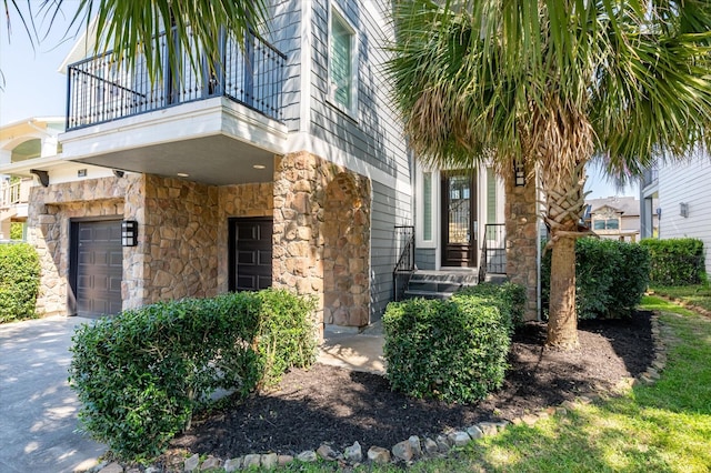 211 Valmar St, Kemah, TX 77565 - property entrance with a balcony, stone siding, and a garage