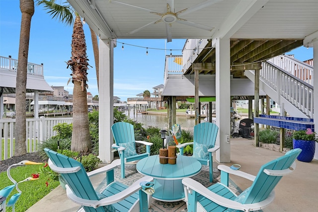 3906 Bridge Harbor Dr, Galveston, TX 77554 - view of patio featuring stairway, a ceiling fan, and a water view