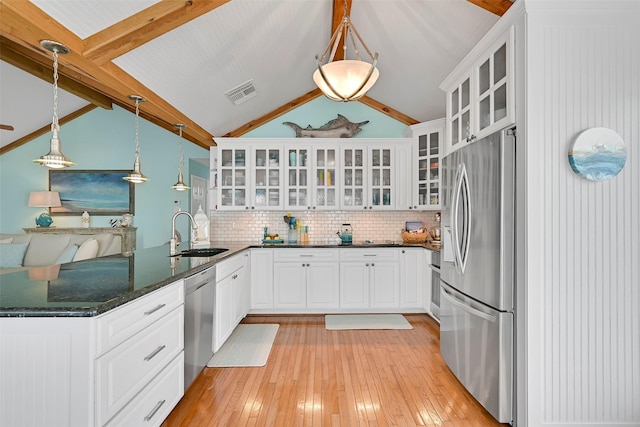 3906 Bridge Harbor Dr, Galveston, TX 77554 - kitchen featuring appliances with stainless steel finishes, a sink, a peninsula, and light wood-style flooring