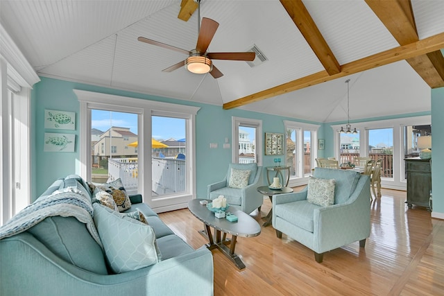 3906 Bridge Harbor Dr, Galveston, TX 77554 - living room with a ceiling fan, healthy amount of natural light, light wood-style floors, and a chandelier