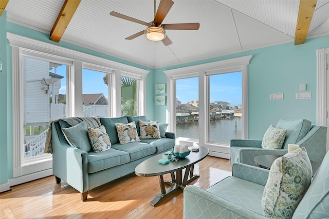 3906 Bridge Harbor Dr, Galveston, TX 77554 - living room featuring ceiling fan, plenty of natural light, light wood finished floors, a baseboard heating unit, and beamed ceiling