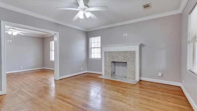 4208 Walker St, Houston, TX 77023 - unfurnished living room with a ceiling fan, light wood-style floors, baseboards, crown molding, and a high end fireplace