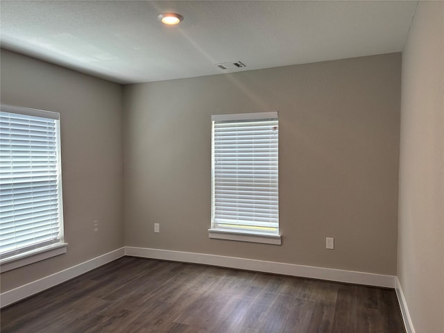 8302 Tavenor Ln, Houston, TX 77075 - unfurnished room featuring baseboards and dark wood-style flooring