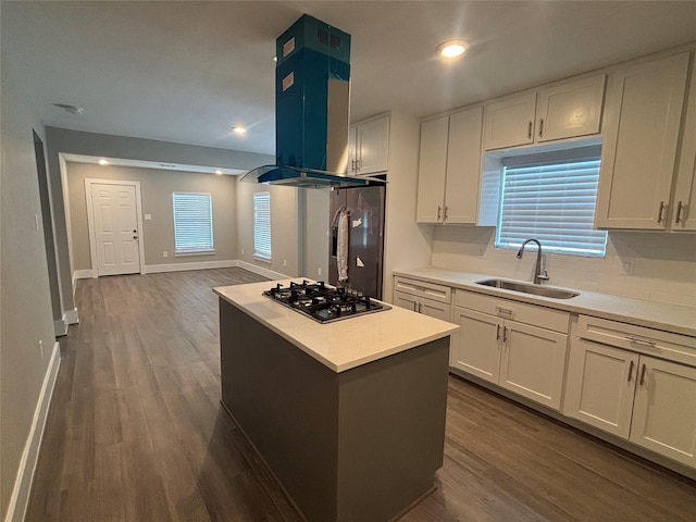8302 Tavenor Ln, Houston, TX 77075 - kitchen featuring a sink, gas cooktop, range hood, white cabinets, and dark wood finished floors