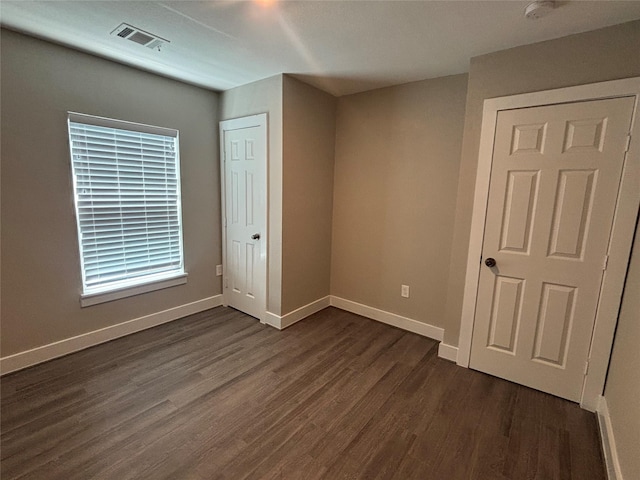 8302 Tavenor Ln, Houston, TX 77075 - unfurnished bedroom with dark wood-style floors and baseboards