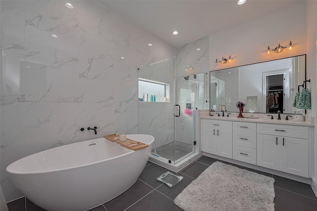 1305 E 27th St Unit A, Houston, TX 77009 - bathroom featuring double vanity, a marble finish shower, a freestanding tub, a spacious closet, and tile patterned floors