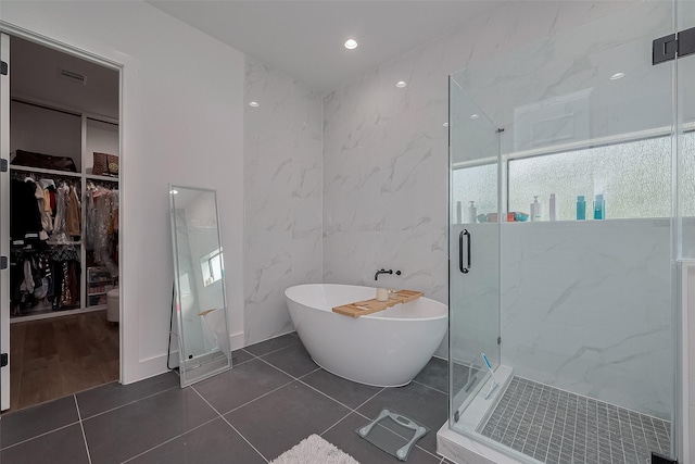 1305 E 27th St Unit A, Houston, TX 77009 - bathroom with a marble finish shower, a freestanding tub, a walk in closet, and tile patterned flooring