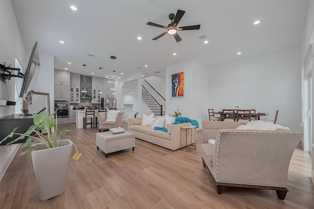 1305 E 27th St Unit A, Houston, TX 77009 - living room with stairs, a ceiling fan, light wood-style floors, and recessed lighting