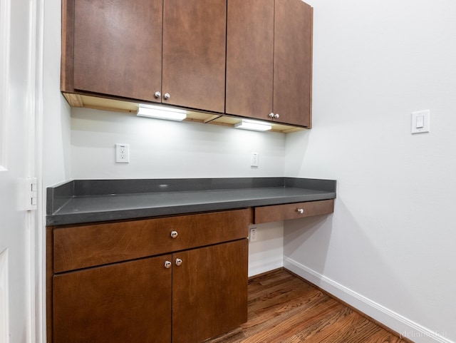 1224 Thompson, Houston, TX 77007 - kitchen featuring dark wood-type flooring, baseboards, and dark countertops
