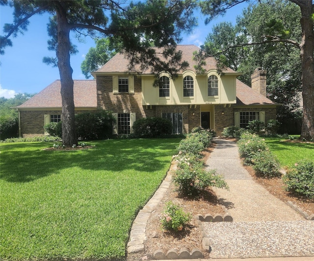 15903 Ridge Park Dr, Houston, TX 77095 - view of front of home with a front lawn, a chimney, and brick siding