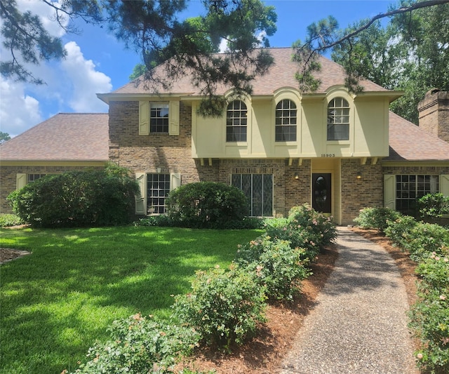 15903 Ridge Park Dr, Houston, TX 77095 - view of front of property featuring a front lawn, brick siding, stucco siding, and a chimney