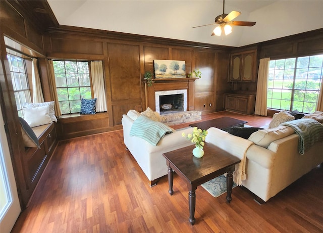 15903 Ridge Park Dr, Houston, TX 77095 - living area with ceiling fan, dark wood-style flooring, a brick fireplace, high vaulted ceiling, and wooden walls
