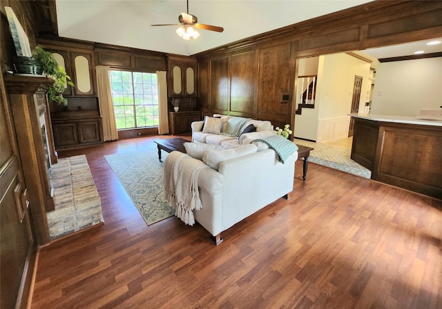 15903 Ridge Park Dr, Houston, TX 77095 - living area with dark wood-style floors, a ceiling fan, lofted ceiling, a decorative wall, and wood walls