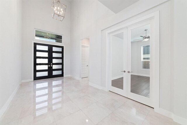 11023 White Caterpillar Dr, Cypress, TX 77433 - tiled foyer entrance featuring french doors, a chandelier, baseboards, and a high ceiling