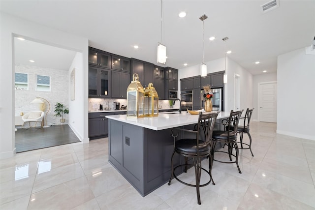 11023 White Caterpillar Dr, Cypress, TX 77433 - kitchen featuring light countertops, tasteful backsplash, a large island, hanging light fixtures, and glass insert cabinets
