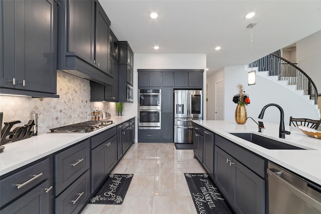 11023 White Caterpillar Dr, Cypress, TX 77433 - kitchen featuring appliances with stainless steel finishes, a sink, light countertops, backsplash, and hanging light fixtures