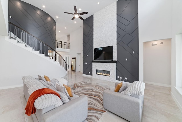 11023 White Caterpillar Dr, Cypress, TX 77433 - living room featuring high vaulted ceiling, stairs, a ceiling fan, a stone fireplace, and baseboards