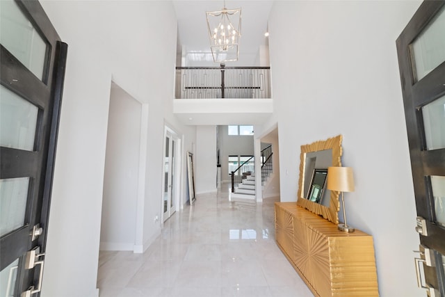 11023 White Caterpillar Dr, Cypress, TX 77433 - foyer entrance featuring a high ceiling, a chandelier, stairway, and baseboards