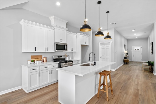 14307 Laredo St, Houston, TX 77015 - kitchen featuring appliances with stainless steel finishes, white cabinets, light wood-style floors, and recessed lighting