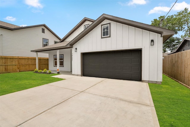 14307 Laredo St, Houston, TX 77015 - view of front of property with driveway, board and batten siding, a fenced backyard, and a garage