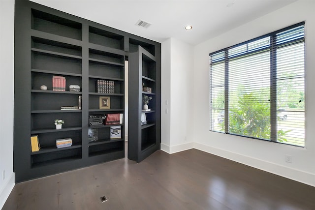4002 Old Chocolate Bayou Rd Unit Cr89, Manvel, TX 77578 - empty room with baseboards, dark wood finished floors, plenty of natural light, built in shelves, and recessed lighting