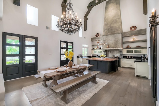 4002 Old Chocolate Bayou Rd Unit Cr89, Manvel, TX 77578 - dining room featuring a high ceiling, a chandelier, french doors, and wood finished floors