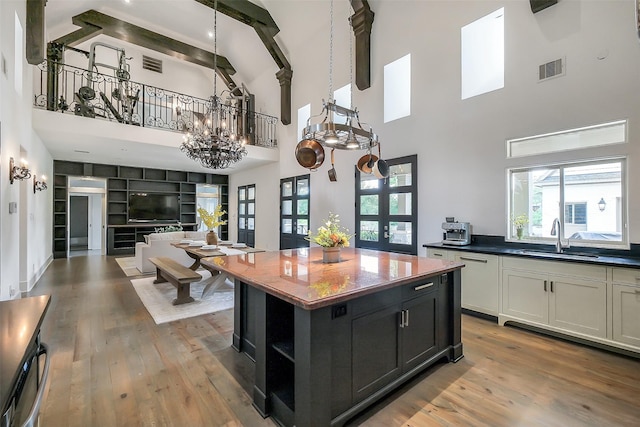 4002 Old Chocolate Bayou Rd Unit Cr89, Manvel, TX 77578 - kitchen with a sink, open shelves, light wood-style flooring, high vaulted ceiling, and a chandelier