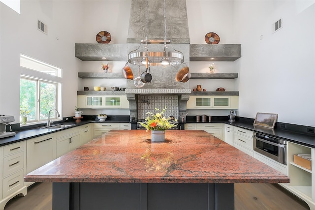 4002 Old Chocolate Bayou Rd Unit Cr89, Manvel, TX 77578 - kitchen featuring a sink, a center island, oven, glass insert cabinets, and open shelves