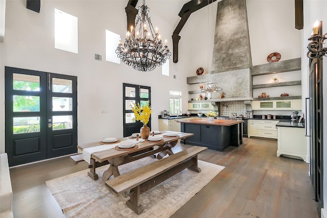 4002 Old Chocolate Bayou Rd Unit Cr89, Manvel, TX 77578 - dining room featuring a high ceiling, french doors, a chandelier, plenty of natural light, and light wood-style flooring