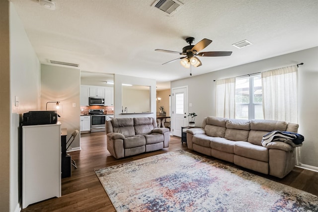 4719 Redbud Place Ln, Richmond, TX 77469 - living area with ceiling fan, dark wood finished floors, and a textured ceiling