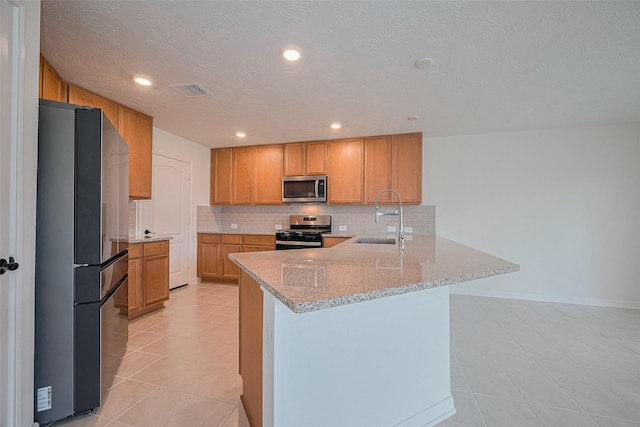 12327 Buck Sable Ln, Houston, TX 77044 - kitchen with appliances with stainless steel finishes, light tile patterned floors, a peninsula, backsplash, and recessed lighting