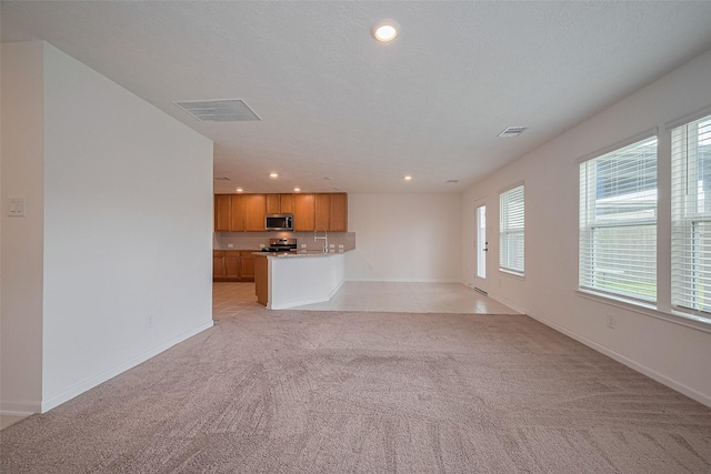 12327 Buck Sable Ln, Houston, TX 77044 - unfurnished living room with light colored carpet and recessed lighting