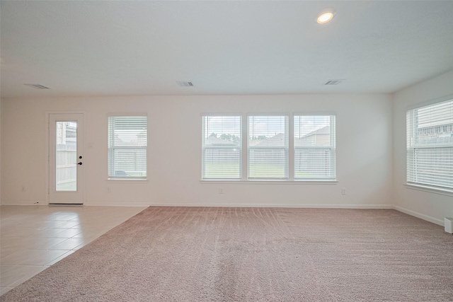 12327 Buck Sable Ln, Houston, TX 77044 - spare room featuring healthy amount of natural light, light colored carpet, recessed lighting, and light tile patterned floors