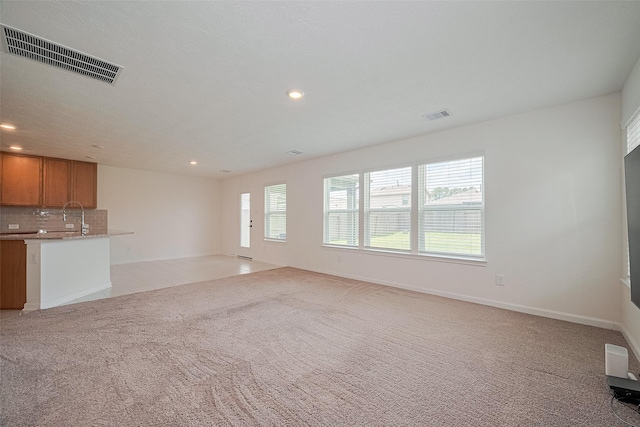 12327 Buck Sable Ln, Houston, TX 77044 - unfurnished living room featuring light colored carpet and recessed lighting