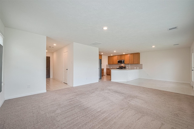 12327 Buck Sable Ln, Houston, TX 77044 - unfurnished living room with light colored carpet, recessed lighting, and light tile patterned floors