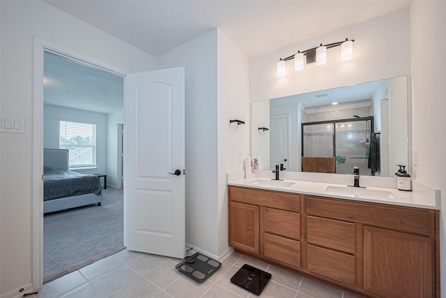 12327 Buck Sable Ln, Houston, TX 77044 - bathroom featuring a stall shower, double vanity, tile patterned flooring, and ensuite bathroom